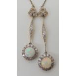 A BELLE EPOCHE STYLE DOUBLE OPAL AND DIAMOND DROP PENDANT set throughout in yellow and white