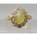 A CHRYSOBERYL AND OLD CUT DIAMOND CLUSTER RING the central chrysoberyl is approx 7.8mm x 5.8mm x 3.