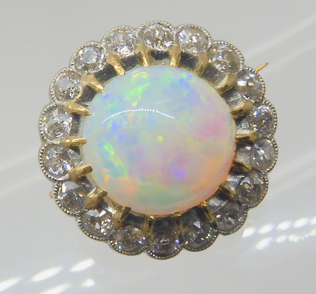 AN OPAL AND DIAMOND BROOCH opal approx 10.4mm in diameter, surrounded with a row of diamonds which - Image 5 of 6