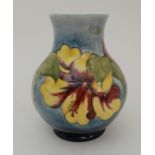 A LIMITED EDITION MOORCROFT HIBISCUS PATTERN VASE the pale blue ground with colourful flowers,
