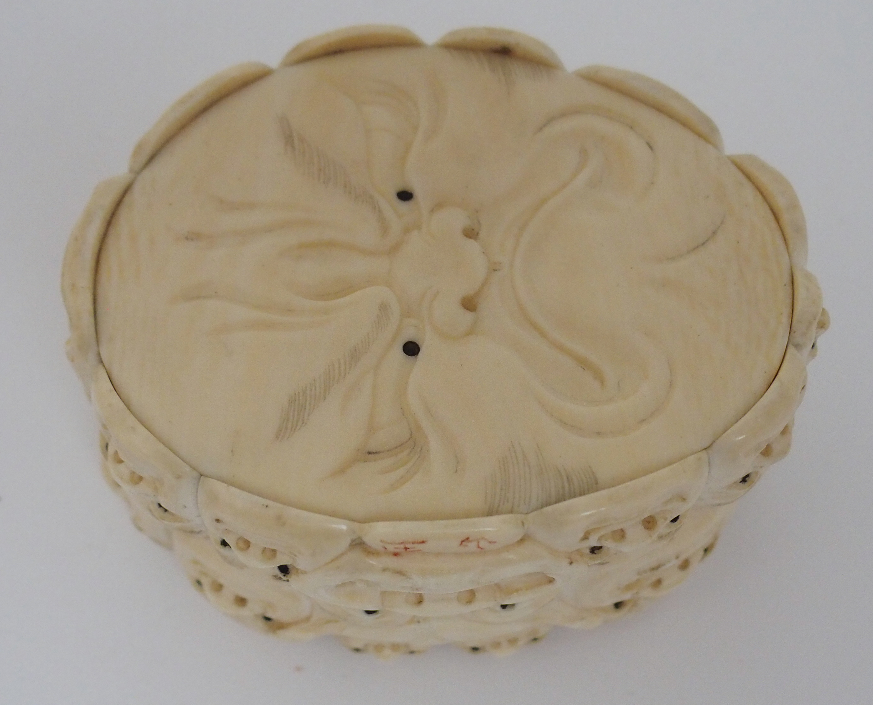 A JAPANESE IVORY OVAL MASK BOX AND COVER carved with many face masks, the cover with mask finial, - Image 13 of 14