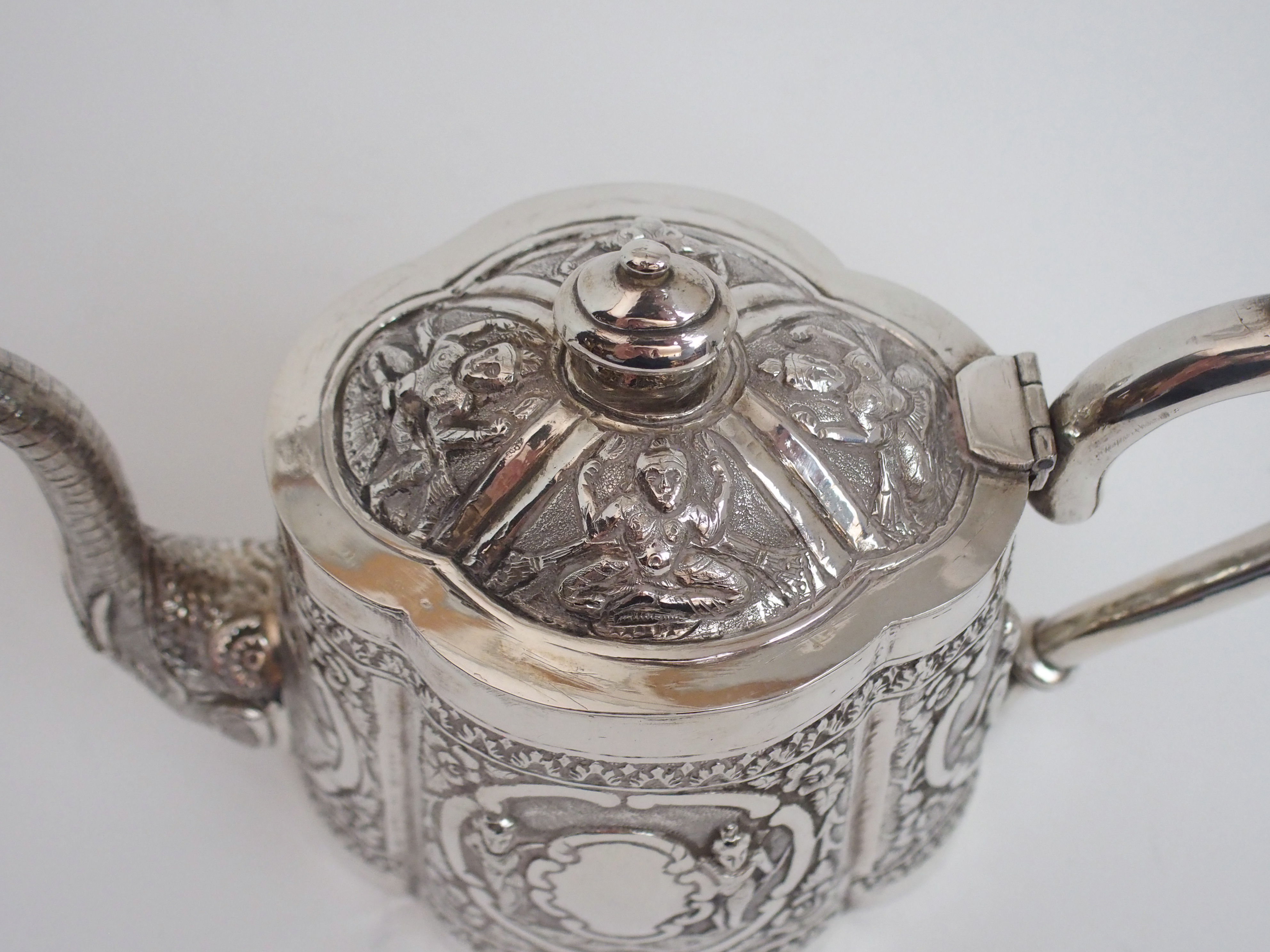 AN ASIAN WHITE METAL THREE PIECE TEA SERVICE cast and decorated with figures in cartouche panels - Image 7 of 13