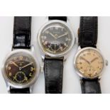 THREE MILITARY STAINLESS STEEL WATCHES the smaller of the three has a cream dial, black Arabic
