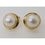 A PAIR OF MABE PEARL AND DIAMOND CUFFLINKS diameter of mabe pearl approx 15mm, set in bright