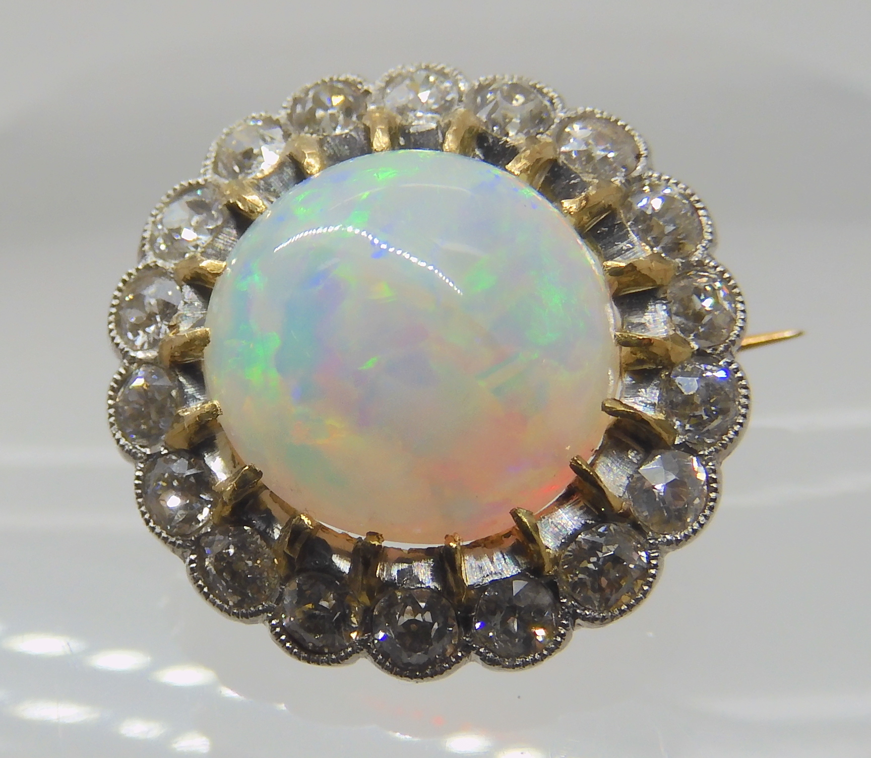 AN OPAL AND DIAMOND BROOCH opal approx 10.4mm in diameter, surrounded with a row of diamonds which - Image 4 of 6