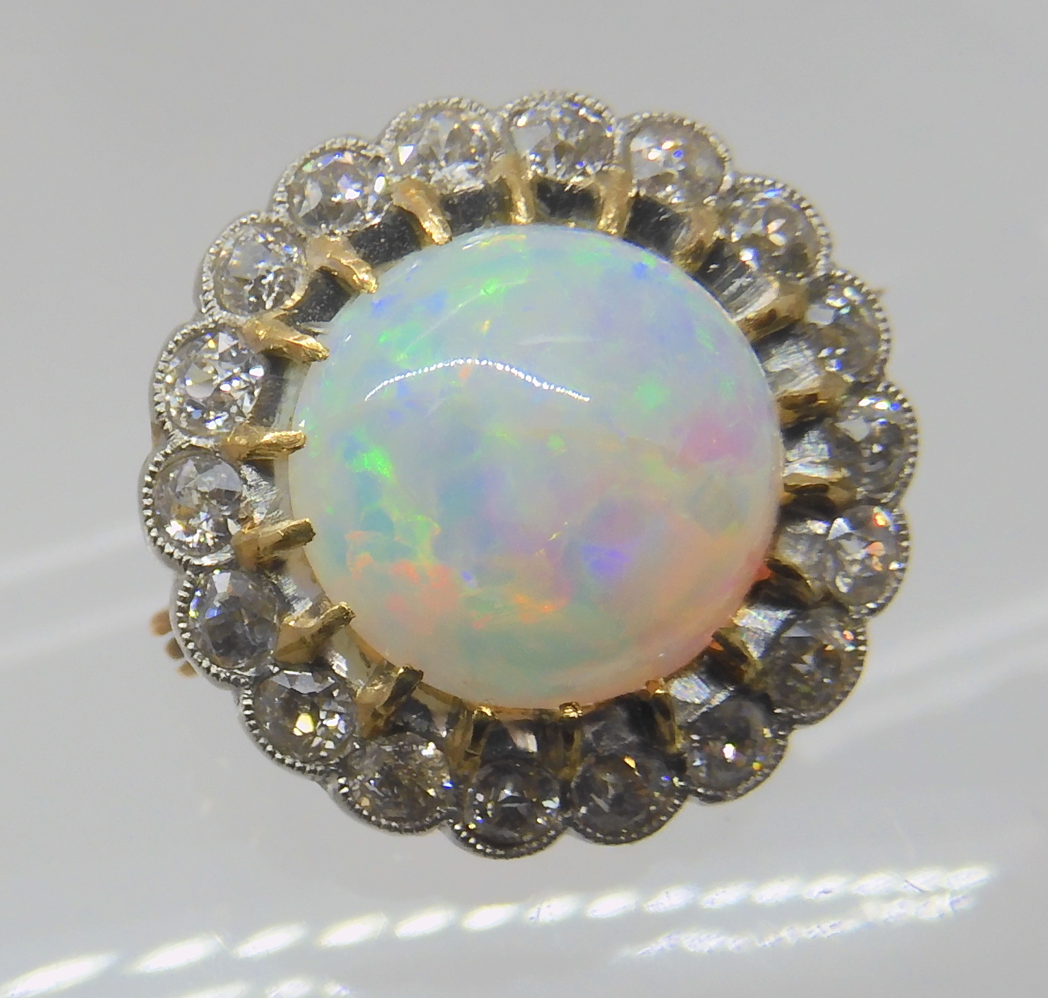 AN OPAL AND DIAMOND BROOCH opal approx 10.4mm in diameter, surrounded with a row of diamonds which - Image 2 of 6
