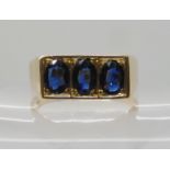 A 14K GOLD GENTS THREE SAPPHIRE RING each sapphire approx 7mm x 4.7mm x 2.3mm, finger size 2 1/2.