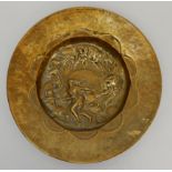 A BRASS ARTS AND CRAFTS DISH decorated with the signs of the zodiac, 46cm diameter Condition Report: