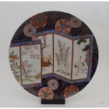 AN IMARI CHARGER painted with a five section screen with a scholar and deer, red capped cranes,
