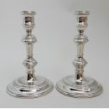 A PAIR OF GEORGIAN STYLE SILVER CANDLESTICKS by Harrods Limited (Richard Woodman Burbridge),