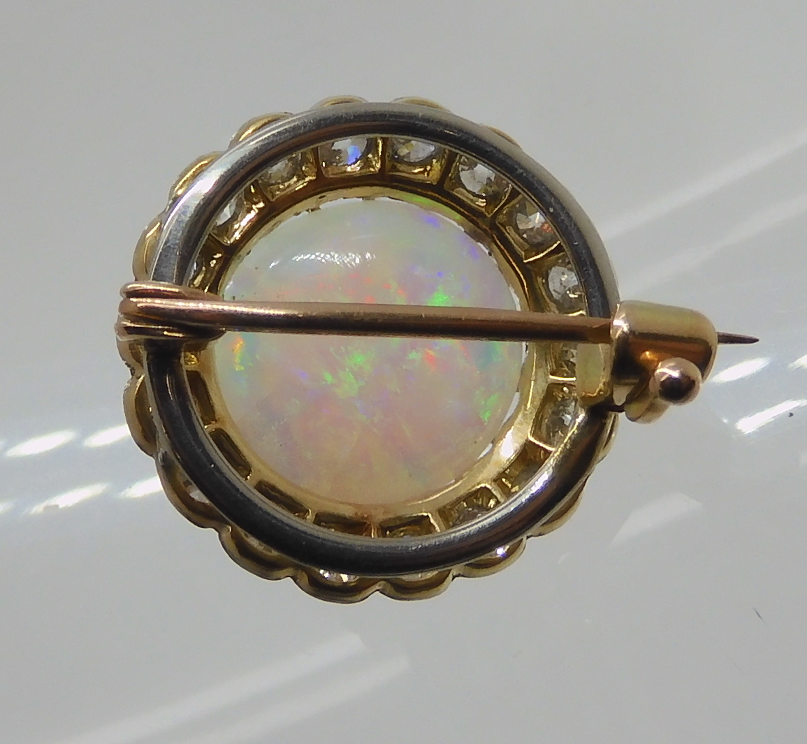 AN OPAL AND DIAMOND BROOCH opal approx 10.4mm in diameter, surrounded with a row of diamonds which - Image 6 of 6