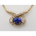 A 14K GOLD TANZANITE AND DIAMOND NECKLET the oval tanzanite of approximately 8.6mm x 6.8mm x 5.