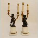 A PAIR OF LATE 19TH/EARLY 20TH CENTURY BRONZE TABLE LAMPS one modelled as a seated cherub, the other