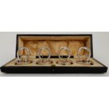 A CASED SET OF FOUR SILVER PLACECARD OR MENU HOLDERS by Levi & Salaman, Birmingham 1909, modelled as