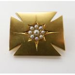 A YELLOW METAL CROSS SHAPED BROOCH SET WITH PEARLS engraved verso 9ct, dimensions 2.9cm x 2.4cm,