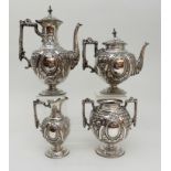 AN EDWARDIAN FOUR PIECE SILVER TEA AND COFFEE SERVICE by Walker & Hall, Sheffield 1907, of bulbous