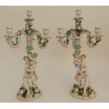 A PAIR OF CONTINENTAL FIGURAL CANDELABRA both modelled as a seated maiden holding a child,
