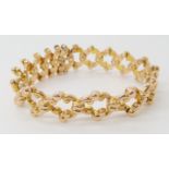 A 15CT GOLD EXPANDABLE BRACELET with decorative scrolled links, maximum expansion approx 7cm, weight