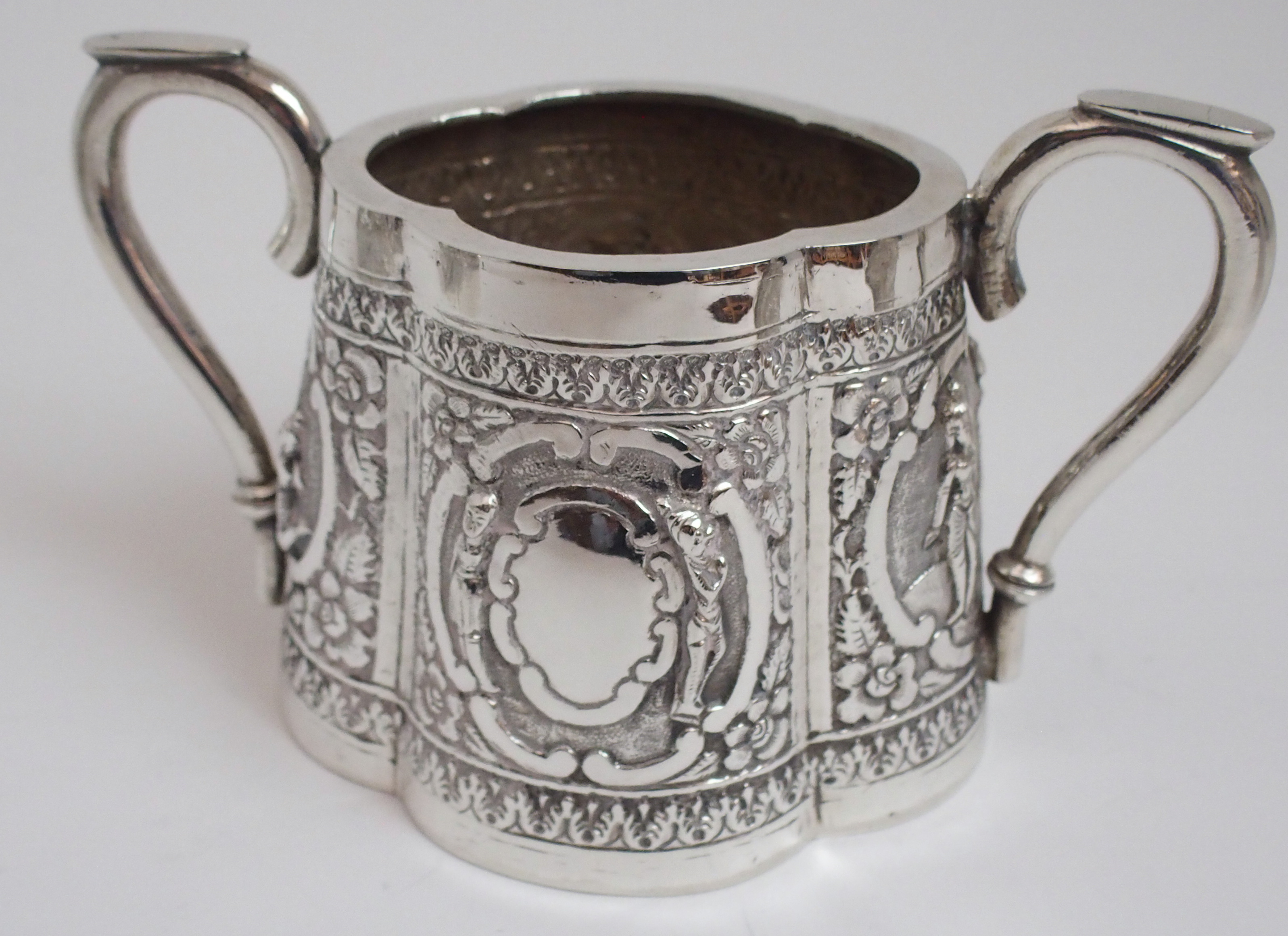 AN ASIAN WHITE METAL THREE PIECE TEA SERVICE cast and decorated with figures in cartouche panels - Image 10 of 13