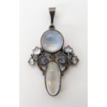 A MOONSTONE AND ENAMEL PENDANT IN THE STYLE OF JESSIE M. KING mounted in white metal, length 4.2cm x