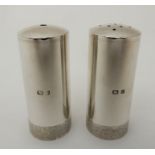 A SALT AND PEPPER by Stuart Devlin, London 1989 and 1991, of plain cylindrical form with a