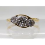 AN 18CT AND PLATINUM THREE STONE RING with a combined estimated approx total of 0.45cts, finger size
