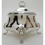A SILVER TEA CADDY unclear maker's marks, Chester 1906, of four sided bombe shape with hinged