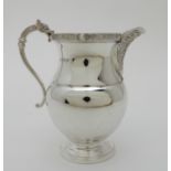 A SILVER CREAM JUG by Adie Brothers Limited, Birmingham 1964, of baluster form with a Celtic