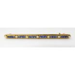 A 15CT GOLD BLUE GEM AND PEARL BROOCH BY SAUNDERS & SHEPHERD of linear form set with blue square