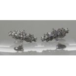 A PAIR OF PLATINUM DIAMOND CLUSTER EARRINGS set with estimated approx 0.50cts of brilliant cut and