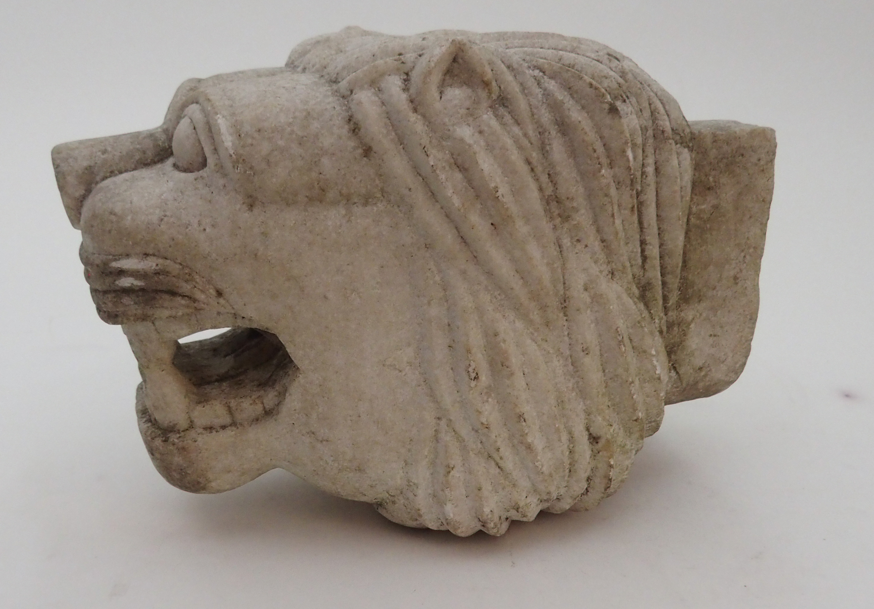 AN INDIAN WHITE MARBLE FOUNTAIN HEAD carved as a snarling lion, 20.5cm high, 16.5cm wide and 29cm