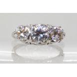 A PLATINUM AMERICAN 'BIRKS' THREE STONE DIAMOND RING with pretty filigree setting further set with