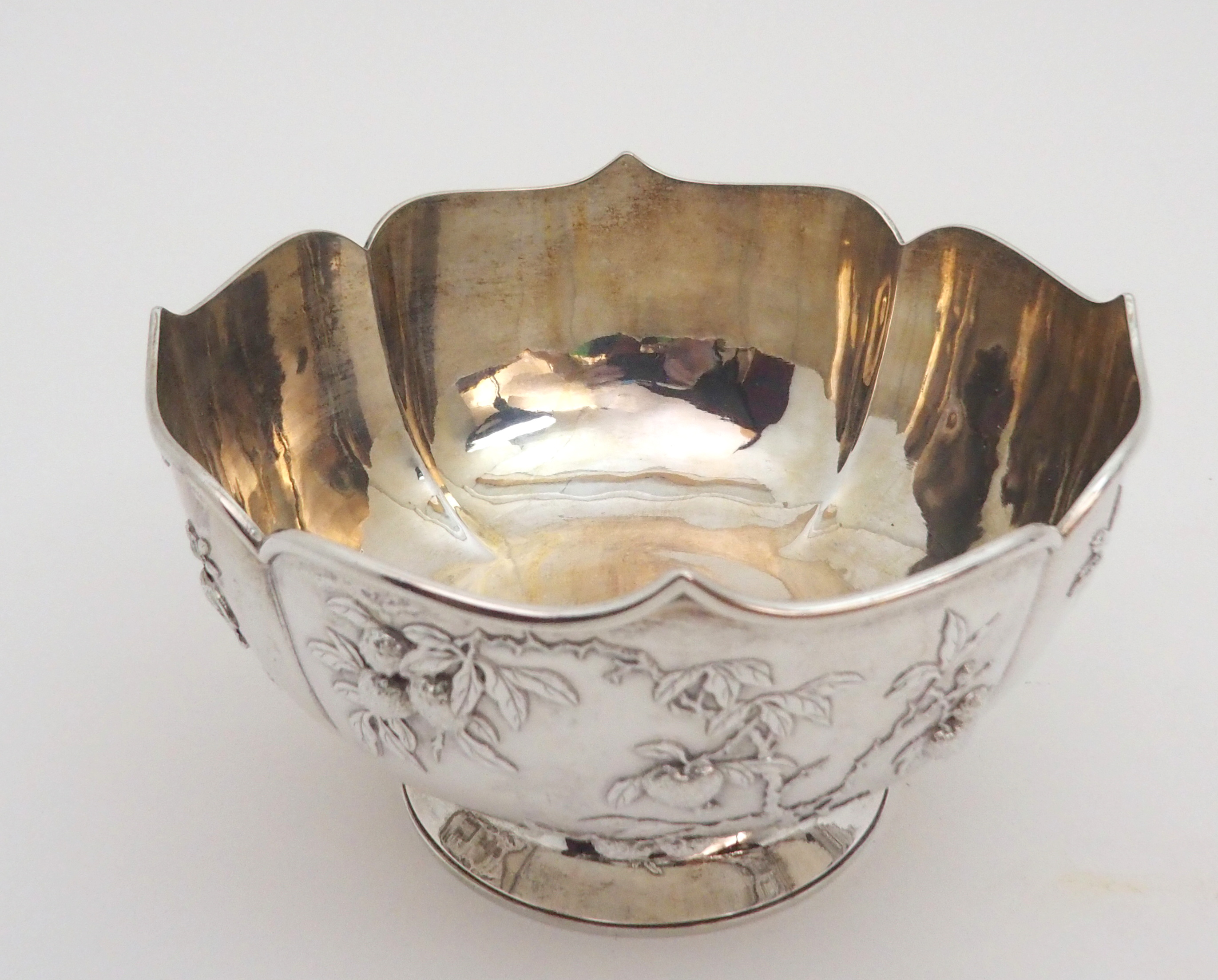 A CHINESE SILVER LOBED BOWL decorated with panels of fruit, beneath a folded rim and stamped, ZEEWO - Image 3 of 6