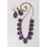 A 9CT AMETHYST FRINGE NECKLACE AND EARRING SET the amethysts are set in galleried mounts, largest