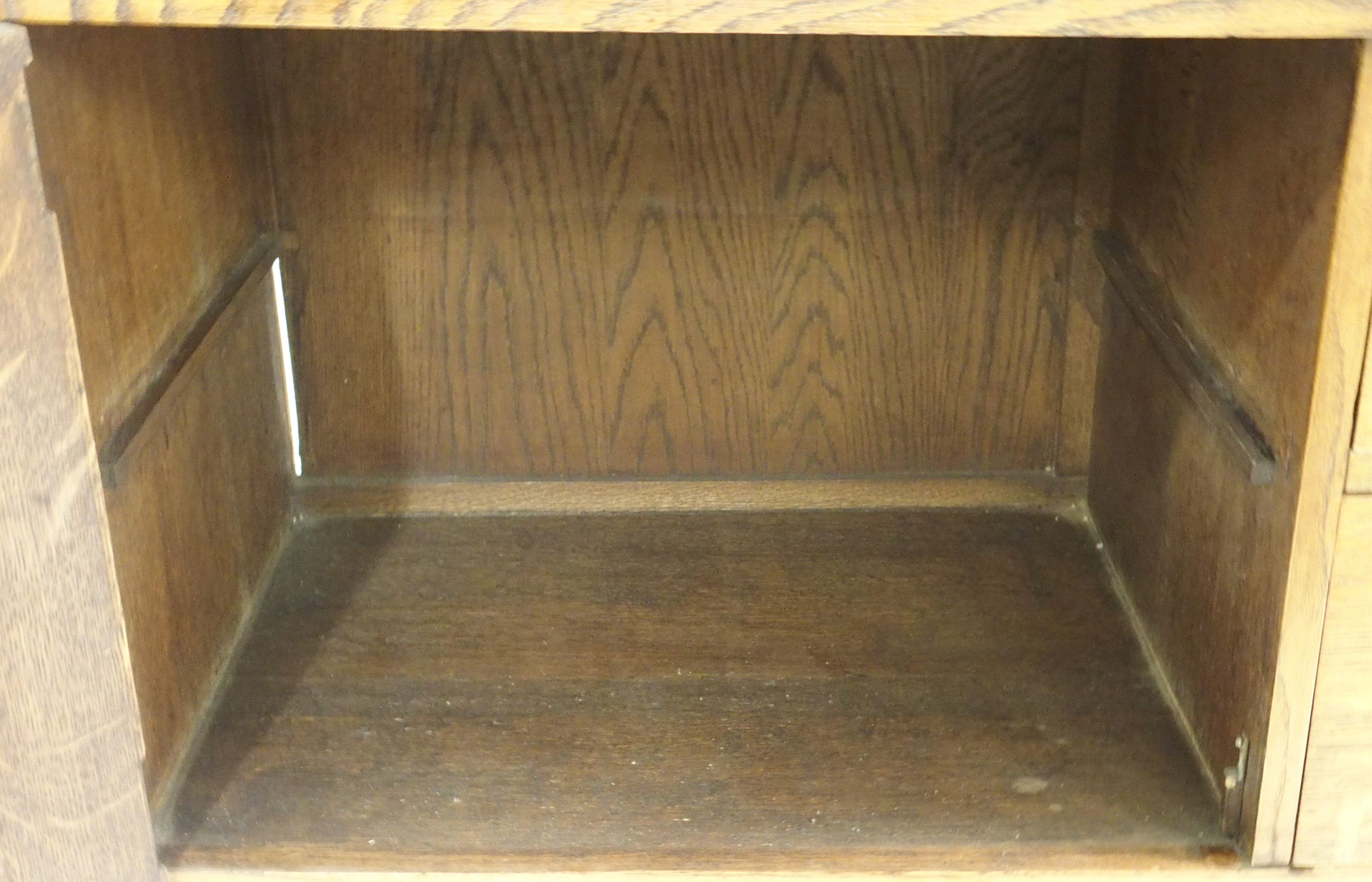 AN ARTS AND CRAFTS OAK DRESSER with open shelves, flanked by embossed inset brass panels and - Image 10 of 15