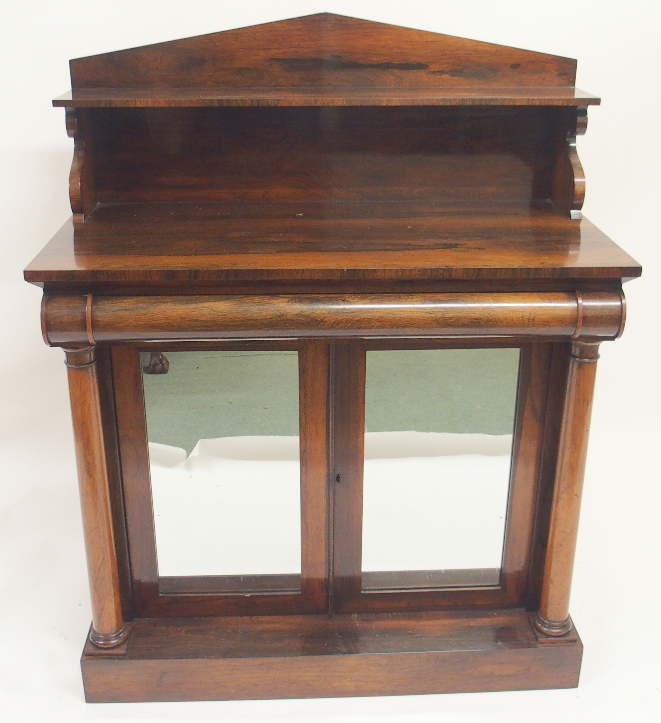 A VICTORIAN ROSEWOOD CHIFFONIER the shelf back above a curved drawer and a pair of mirrored doors,