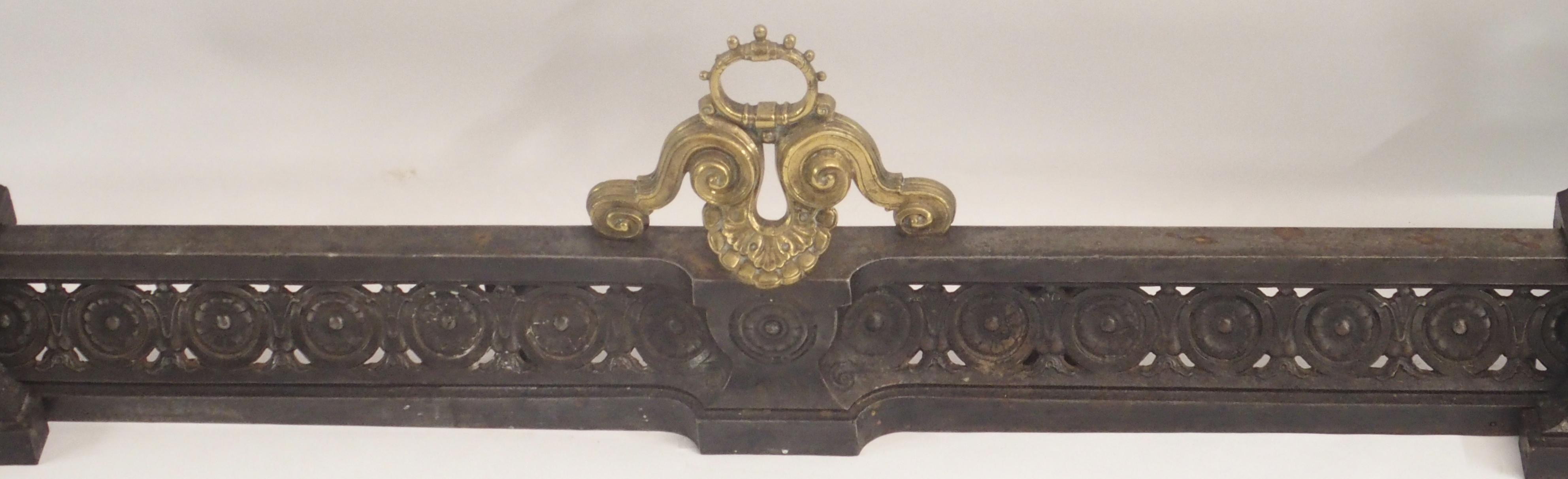 A 19TH CENTURY CAST STEEL AND BRASS FIREPLACE FENDER in three sections, modelled with winged - Image 2 of 15