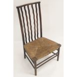A MORRIS & CO, LIBERTYS LATHBACK CHAIR with waved splats above a rush seat and twin spars, 85cm high