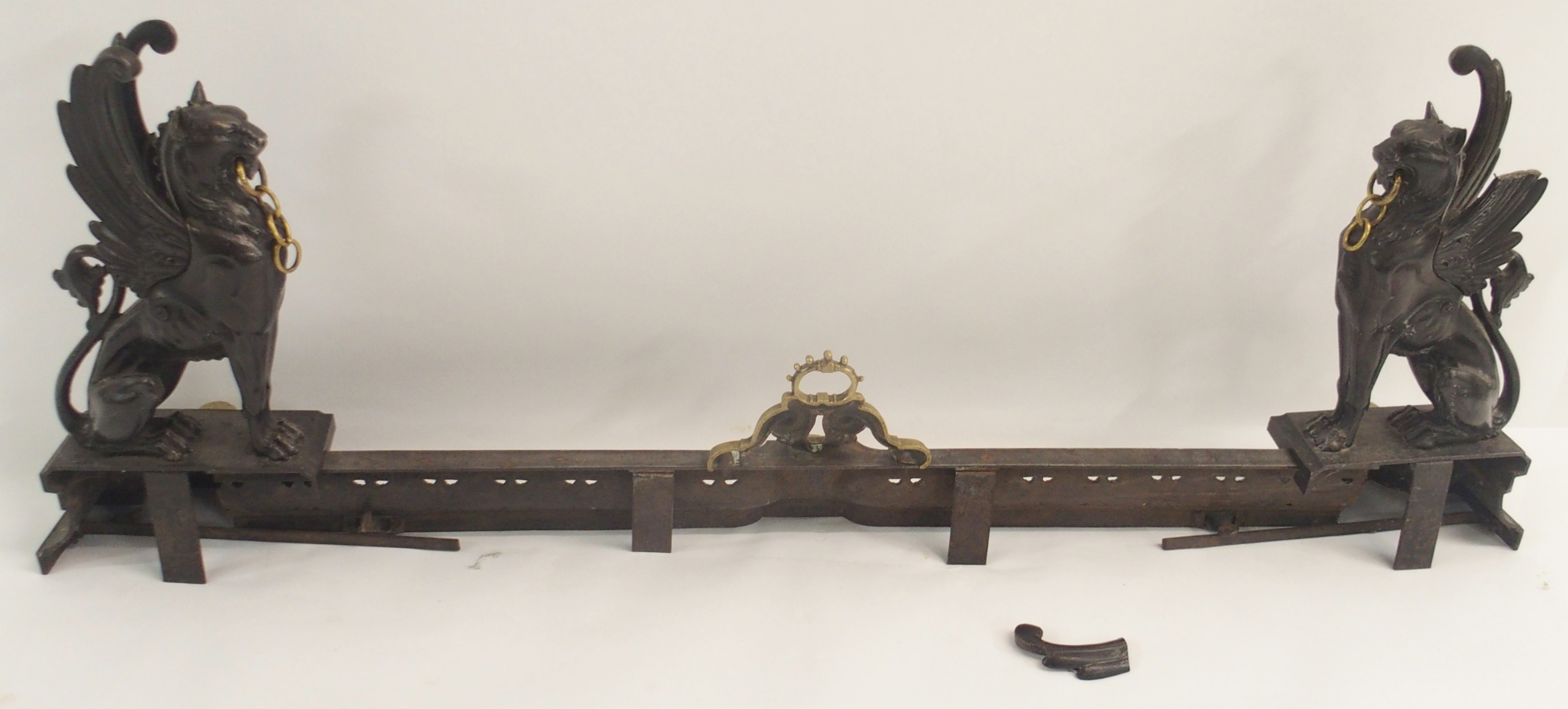 A 19TH CENTURY CAST STEEL AND BRASS FIREPLACE FENDER in three sections, modelled with winged - Image 12 of 15