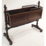 AN EARLY 19TH CENTURY MAHOGANY CRIB the panelled box with three quarter baluster gallery on chain