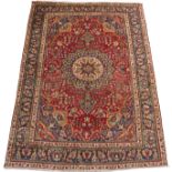 A RED GROUND SAROUGH RUG with blue central medallion, spandrels and border, 206cm x 290cm