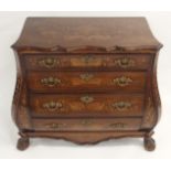 A DUTCH MARQUETRY BOMBE COMMODE decorated with a masked urn issuing foliage above foliate scrolls,