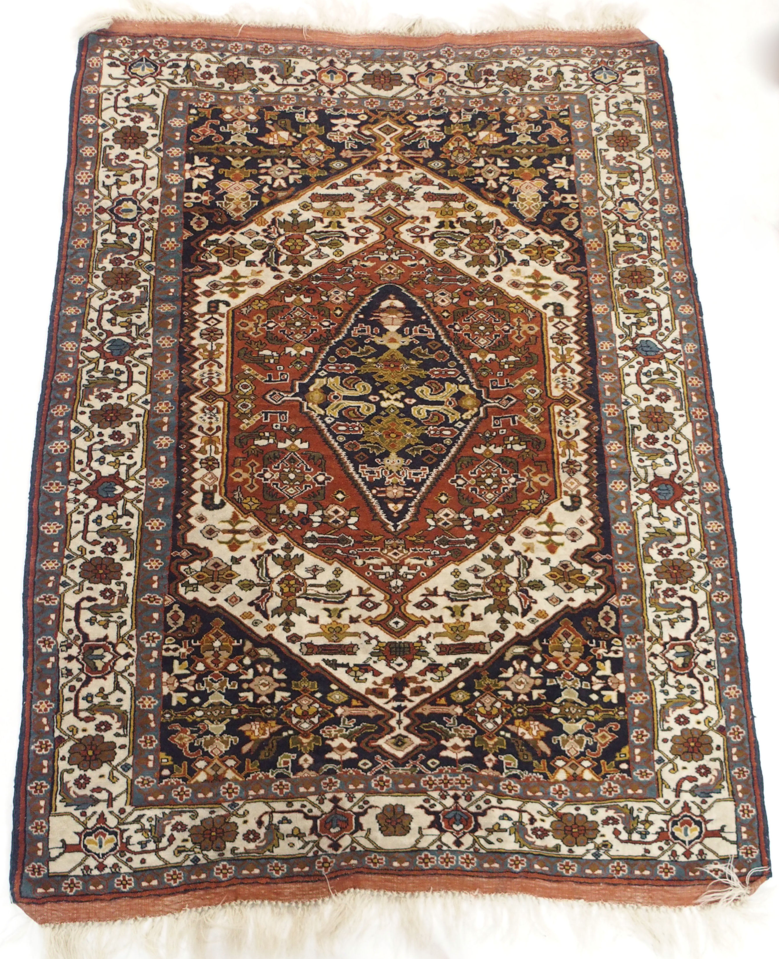 A TERRACOTTA GROUND EASTERN RUG with central medallion, 190cm x 137cm Condition Report: Available