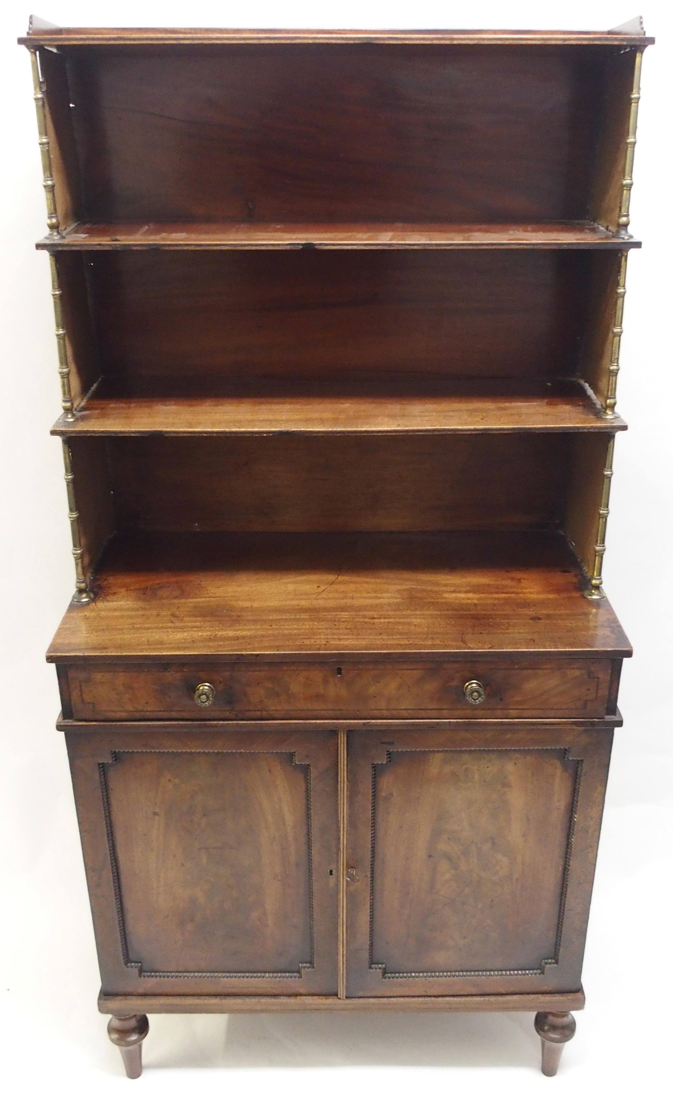 A REGENCY MAHOGANY CAMPAIGN SECRETAIRE BOOKCASE the tiered open shelves joined by brass baluster