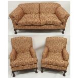 A REPRODUCTION MAHOGANY FRAMED THREE PIECE SUITE with floral patterned upholstery on carved