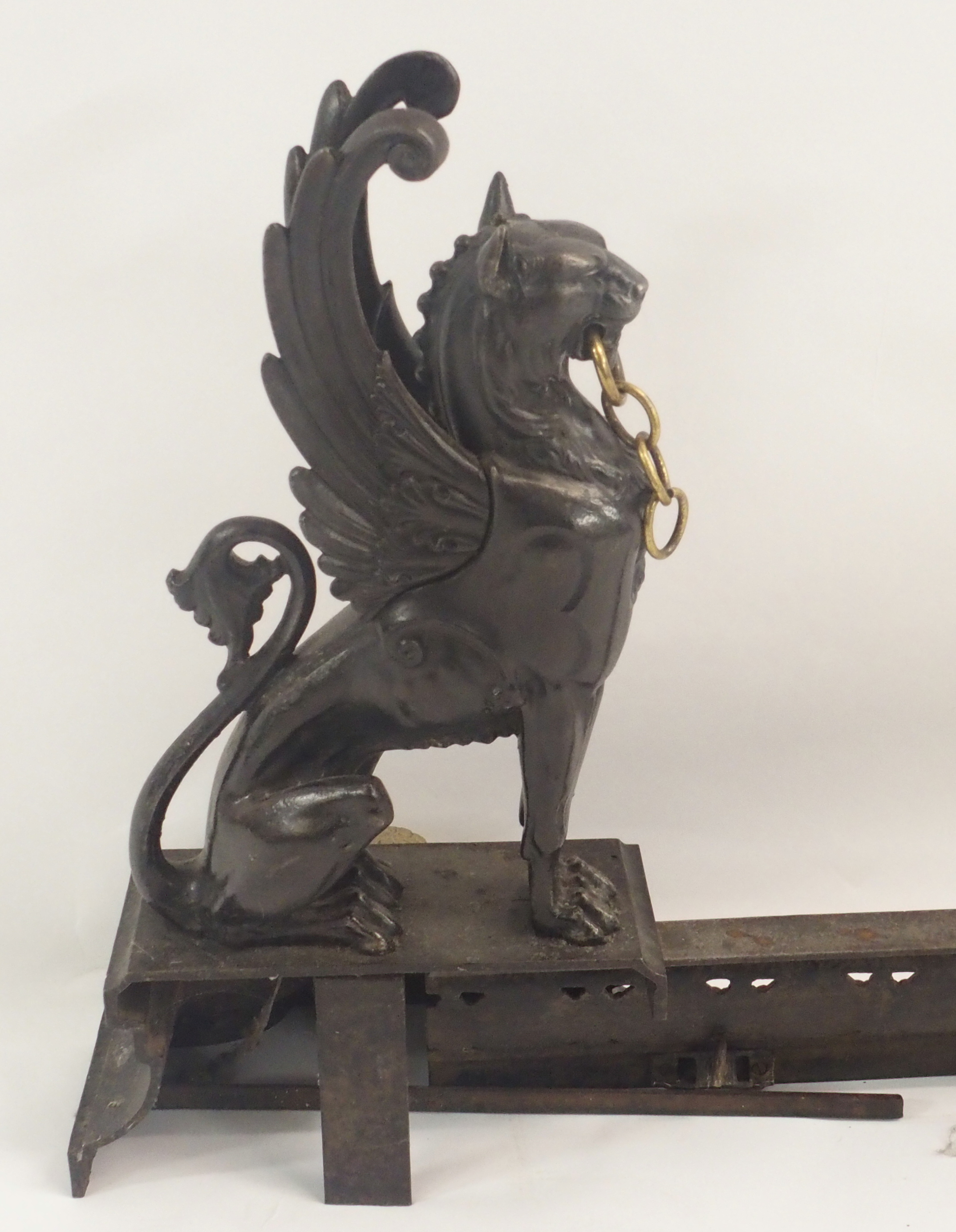 A 19TH CENTURY CAST STEEL AND BRASS FIREPLACE FENDER in three sections, modelled with winged - Image 13 of 15