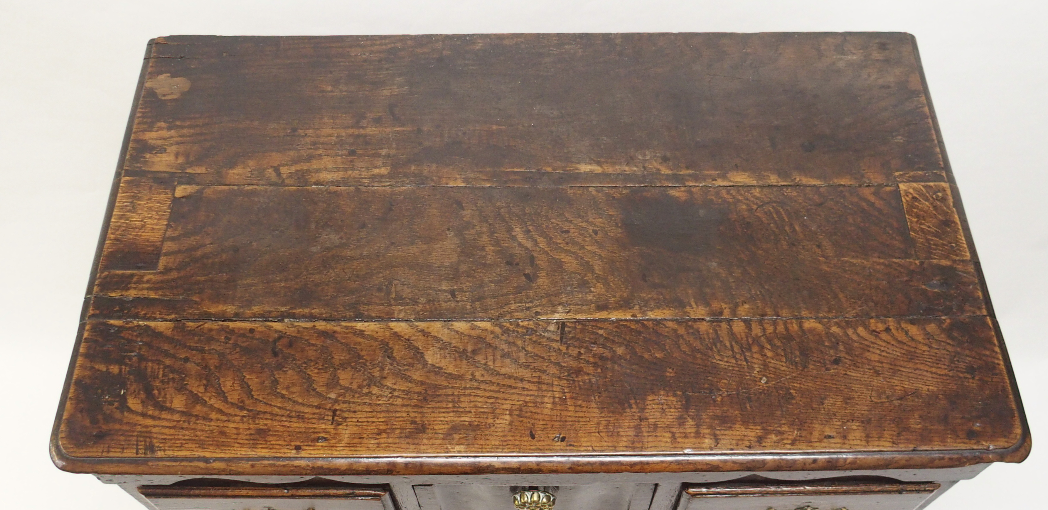 AN 18TH CENTURY OAK CHEST with shaped frieze above a central linen fold drawer, flanked by two short - Image 2 of 8