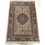 A LIGHT GROUND EASTERN RUG with blue central medallion with signature, 220cm x 139cm Condition