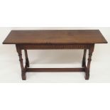 AN OAK HALL TABLE the dentil frieze above ring turned legs, joined by a stretcher, 76cm high,