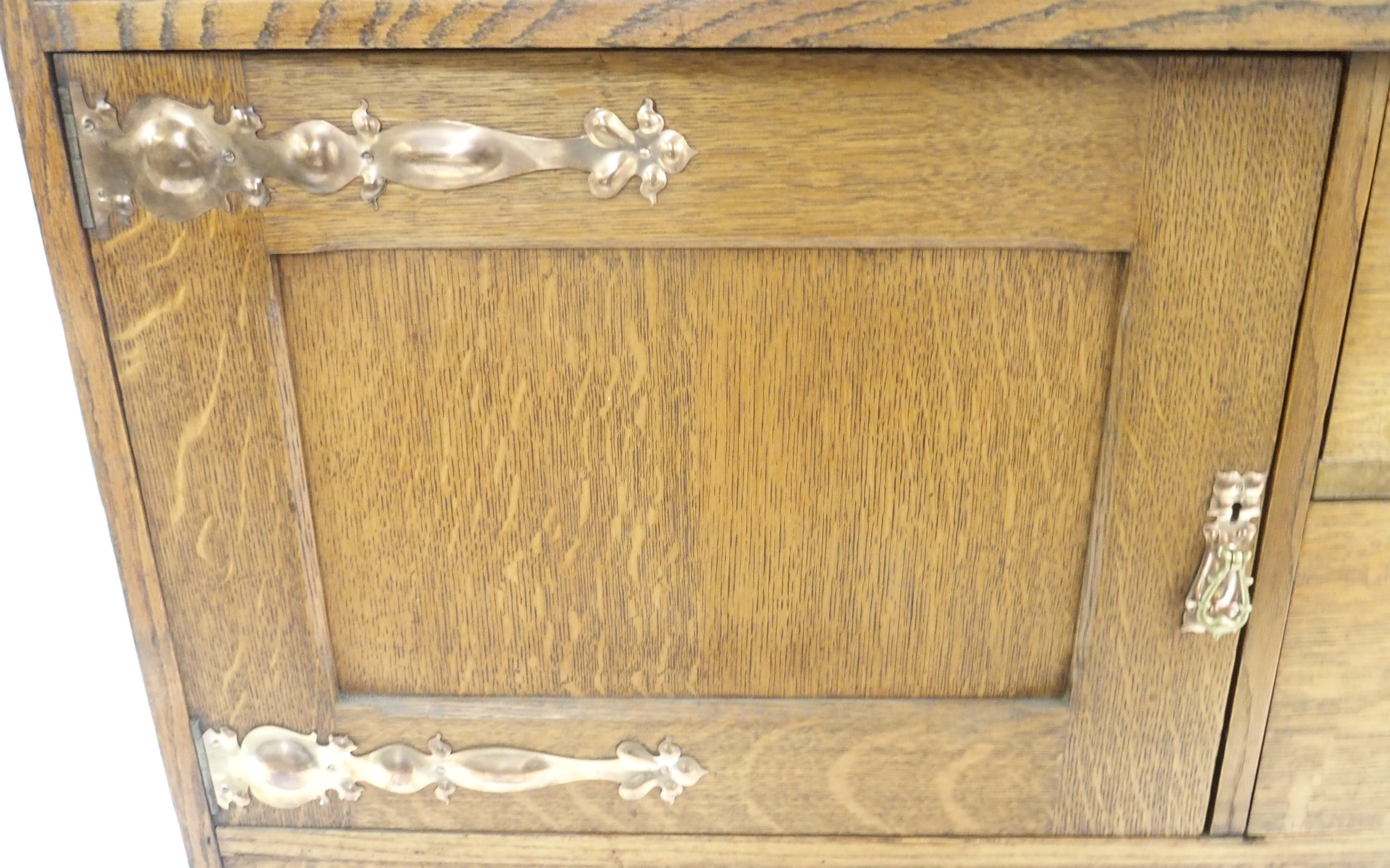 AN ARTS AND CRAFTS OAK DRESSER with open shelves, flanked by embossed inset brass panels and - Image 6 of 15